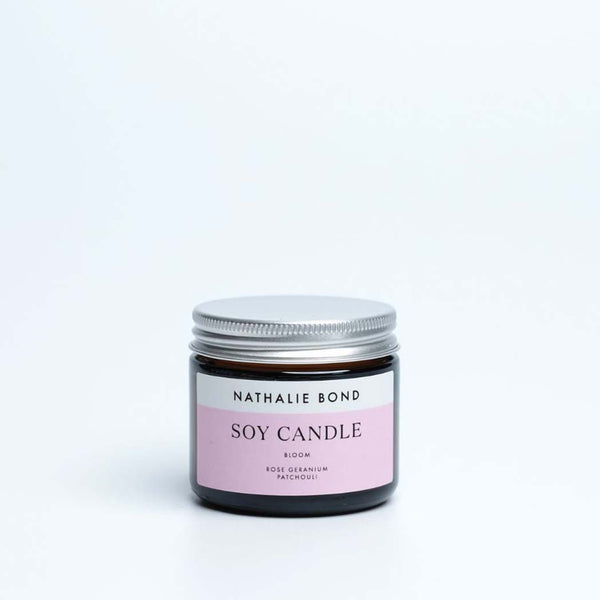 Soy candle with a pink label