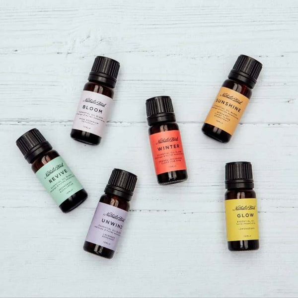 Six essential oil bottles on a wooden background