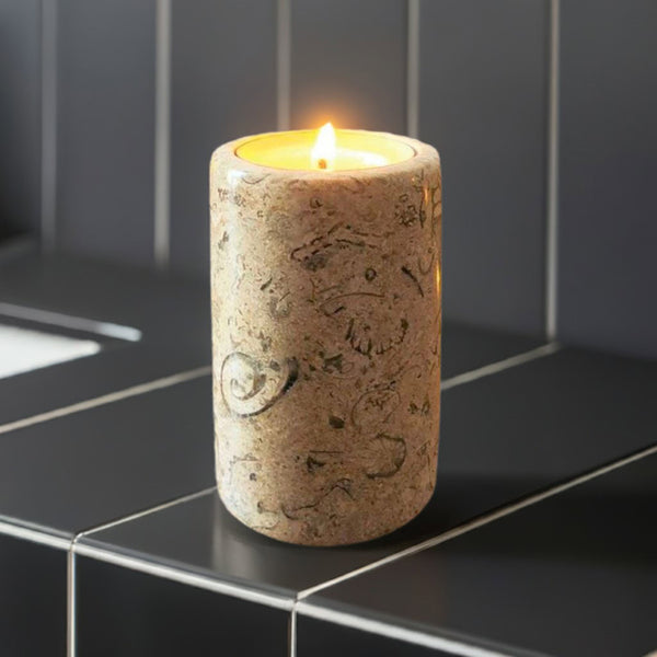 A fossil stone candle by a bathroom sink