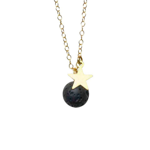 An aromatherapy necklace with a round lava bead pendant and gold star charm