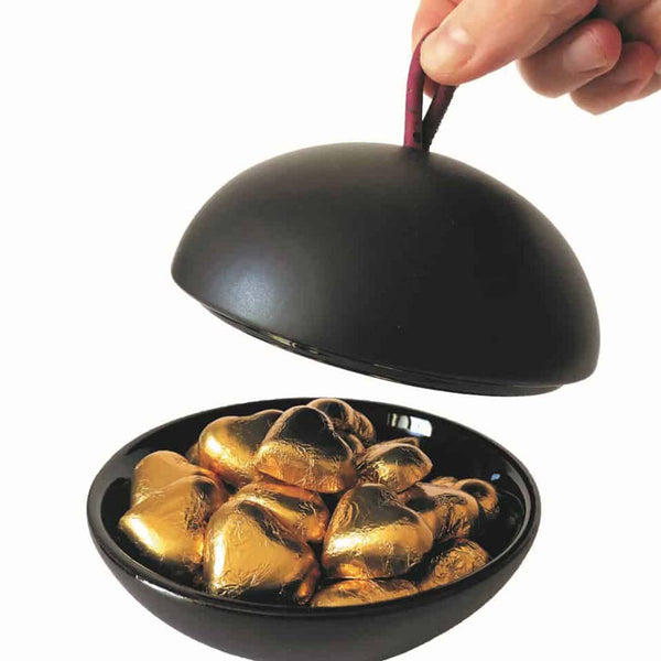Someone removing the lid of a bonbonniere showing chocolates inside