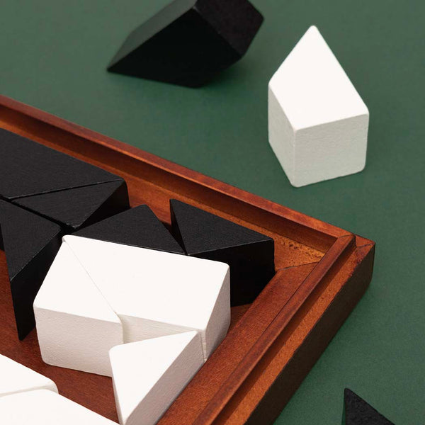 A close up of the black and white wooden playing pieces