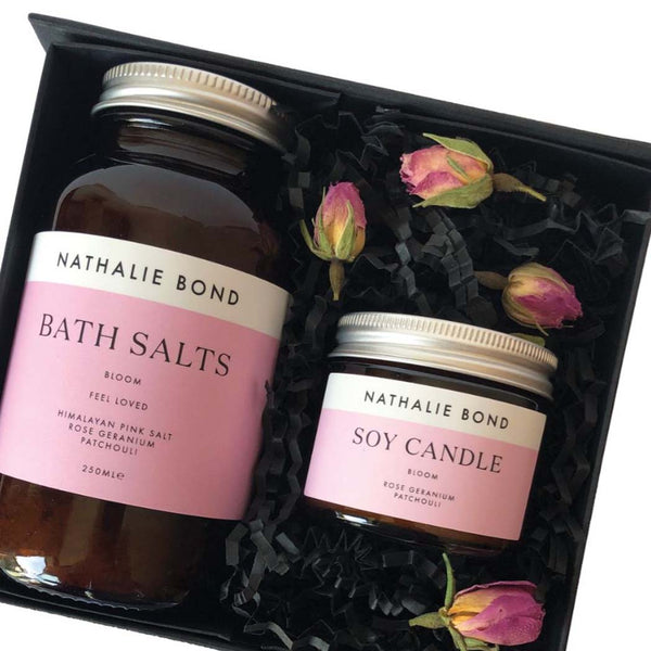 Close up of the bath salts and soy candle in a gift box